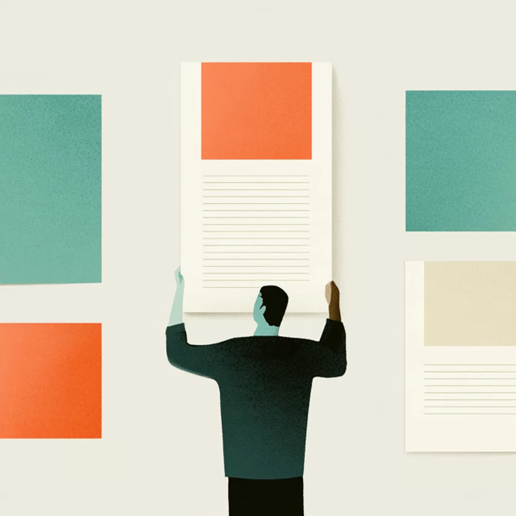 A person seen from behind lifts one instruction card on a wall of cards and flat colour panels in teal, orange and sand